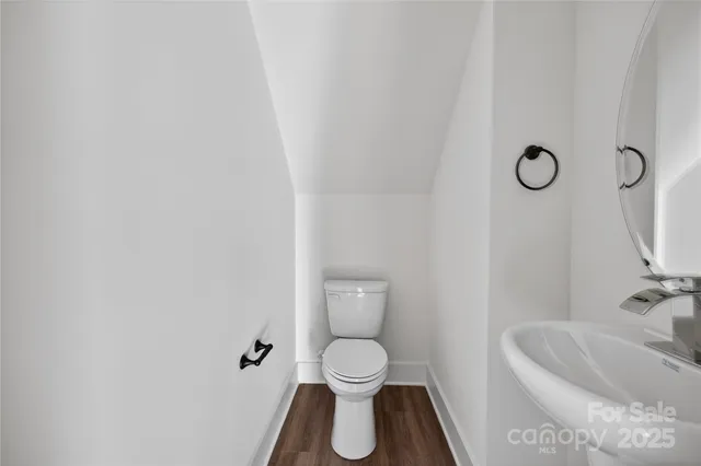 a kitchen with stainless steel appliances granite countertop a refrigerator sink and white cabinets