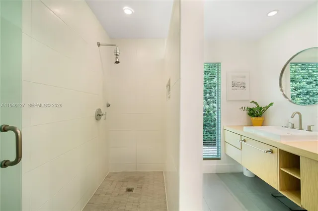 a kitchen with stainless steel appliances granite countertop a sink and a refrigerator