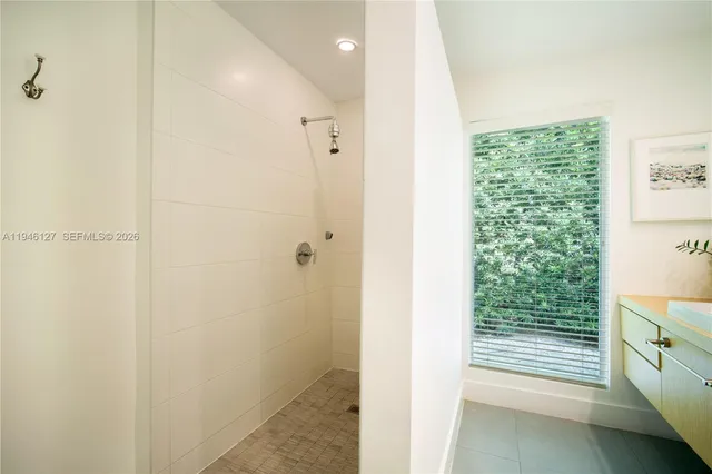 a kitchen with stainless steel appliances kitchen island granite countertop a refrigerator a sink and dishwasher