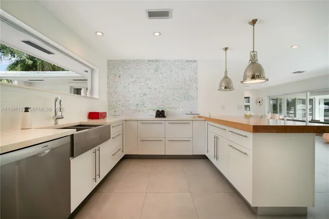 a view of a patio with couches table and chairs with wooden floor and fence