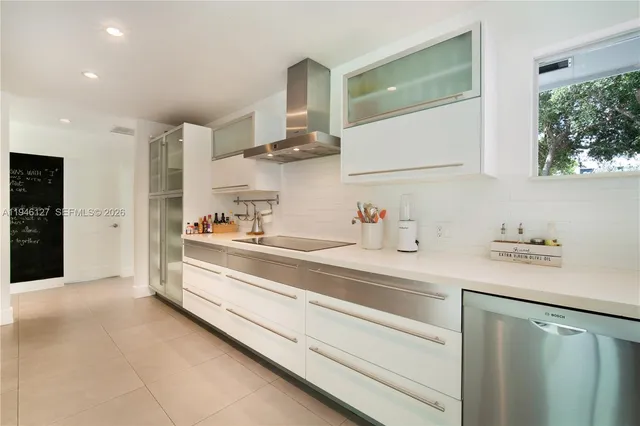 a view of a house with pool and chairs