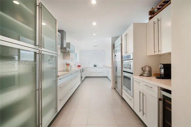 a view of a white house with a big yard and large tree