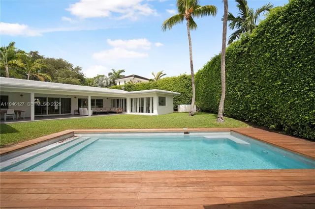 a view of a lake with a table and chairs