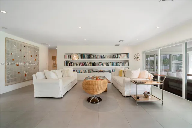 a living room with furniture and a book shelf