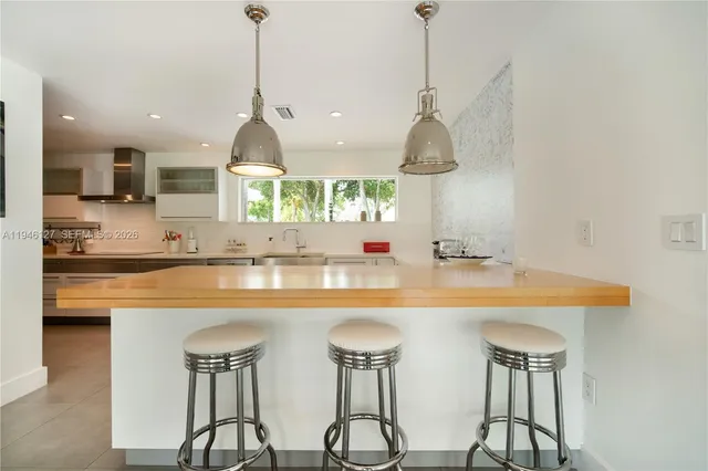 a dining room with furniture and a chandelier