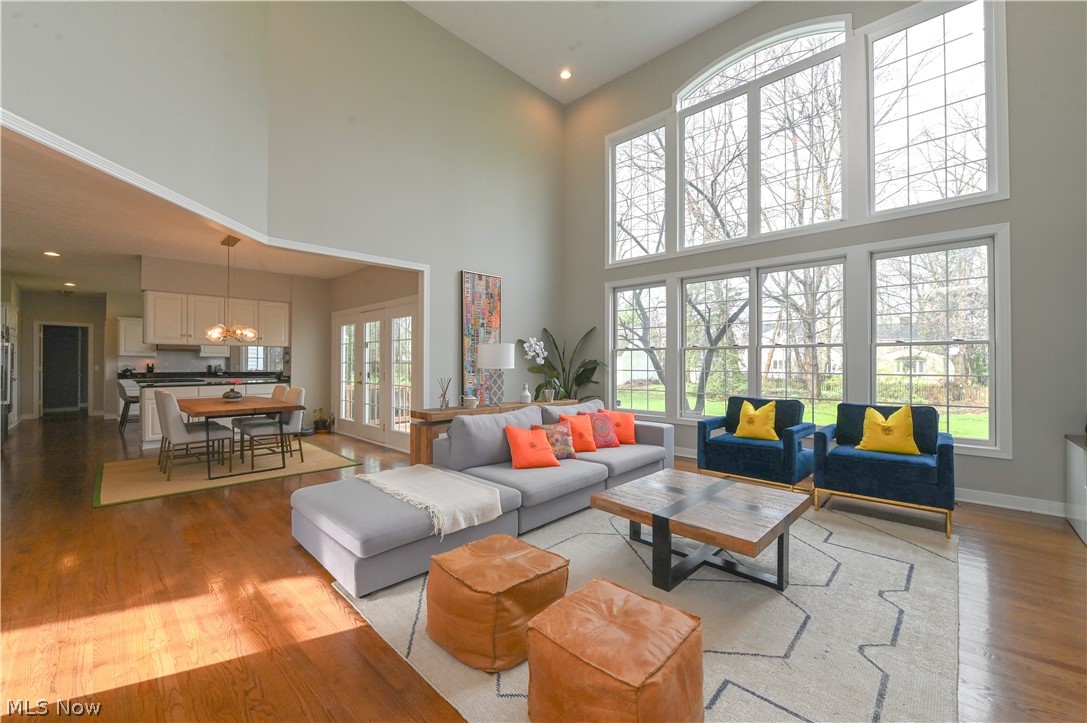 1688 Sheridan Road South Euclid, OH 44121 - Photo 5 of 48 Living room featuring a wealth of natural light, light hardwood / wood-style flooring, a towering ceiling, and a chandelier