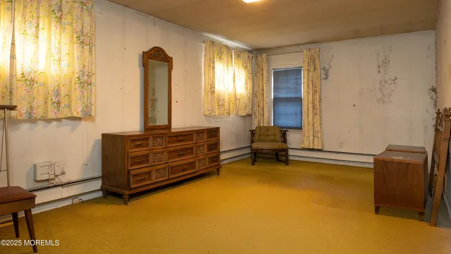 a room with pool table and windows