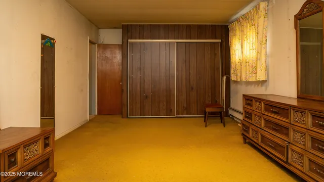 a view of room with window and wardrobe