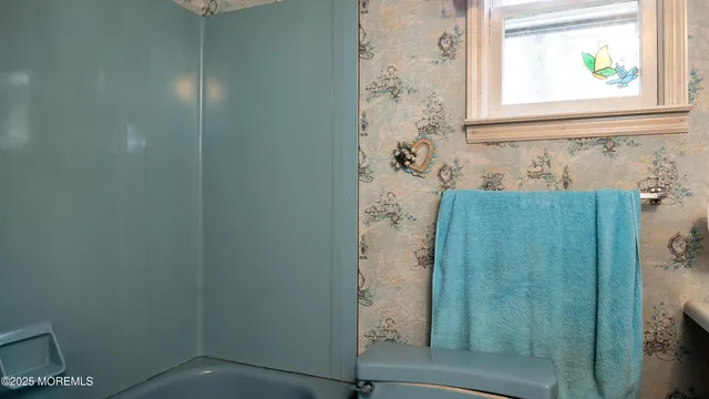 view of a bathroom that has a window in it