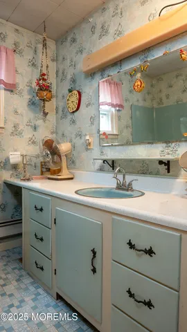 a bathroom with a sink mirror and vanity