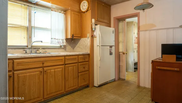 a kitchen with a sink and a refrigerator