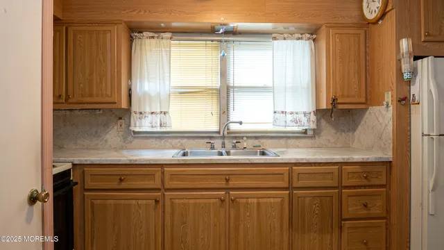 a kitchen with a sink and a window