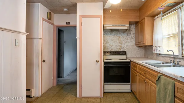 a kitchen with a sink stove and refrigerator