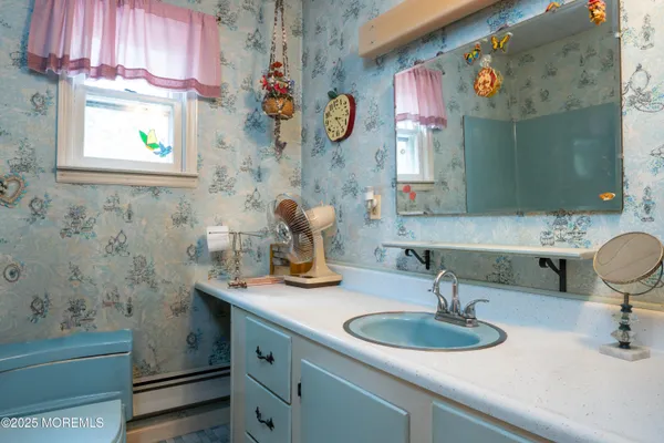 a bathroom with a sink a vanity and a mirror