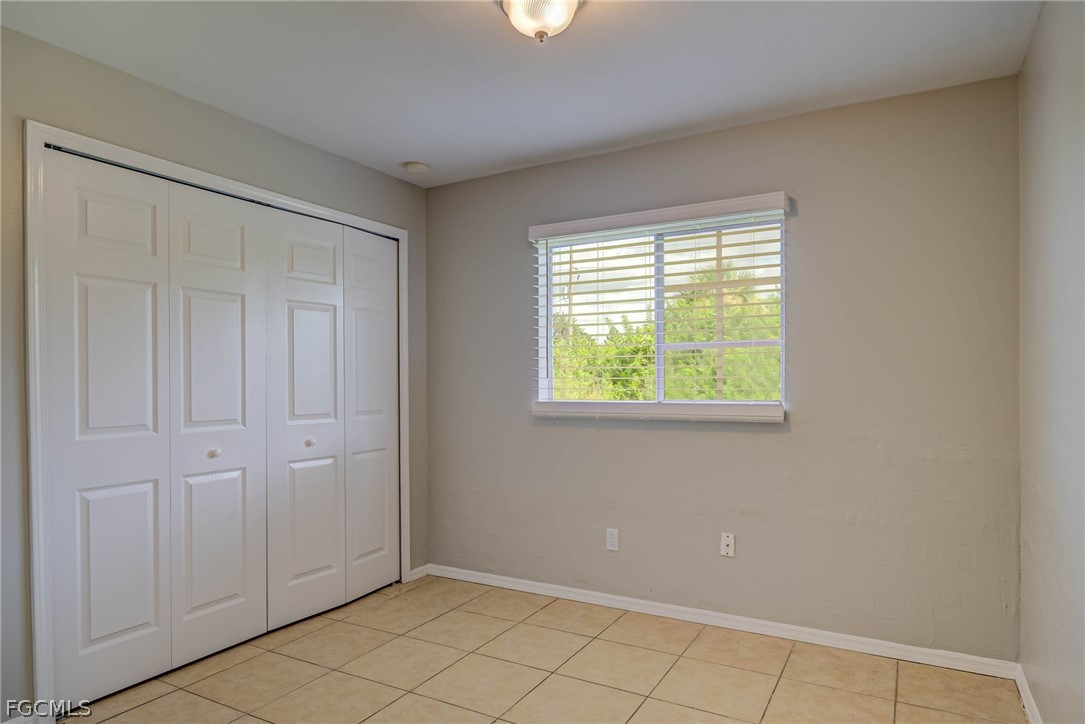 704 Ichabod Avenue Lehigh Acres, FL 33973 - Photo 12 of 22 a view of an empty room with window