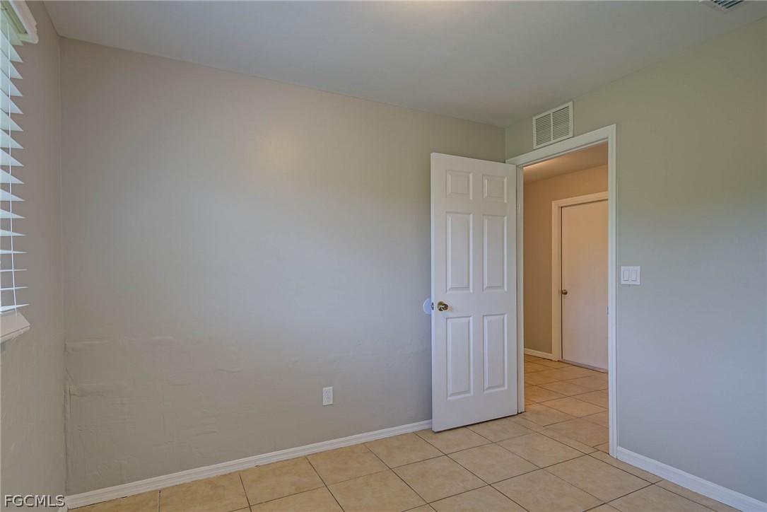 704 Ichabod Avenue Lehigh Acres, FL 33973 - Photo 13 of 22 a view of an empty room