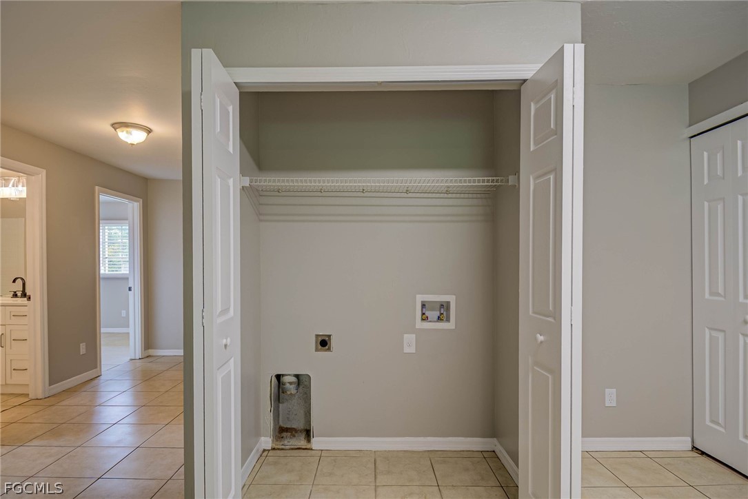 704 Ichabod Avenue Lehigh Acres, FL 33973 - Photo 17 of 22 a view of a hallway with wooden shelves