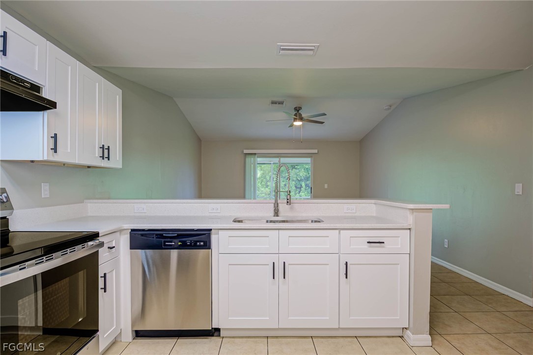 704 Ichabod Avenue Lehigh Acres, FL 33973 - Photo 7 of 22 a kitchen with cabinets appliances and a counter space