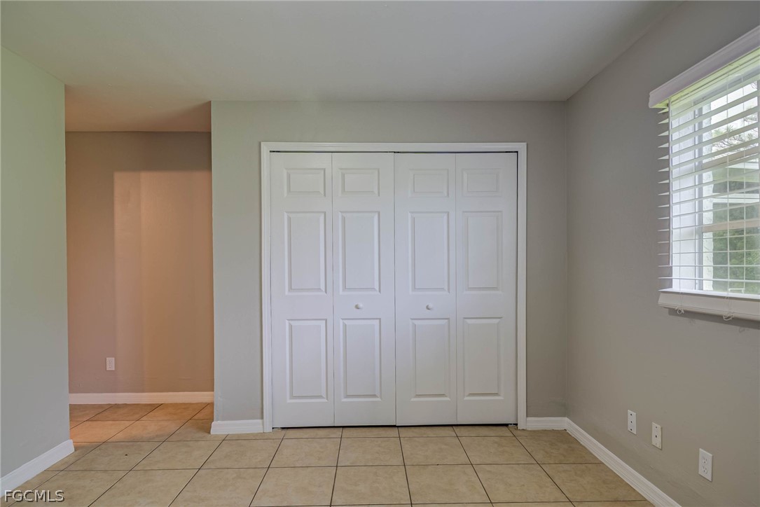 704 Ichabod Avenue Lehigh Acres, FL 33973 - Photo 10 of 22 an empty room with windows