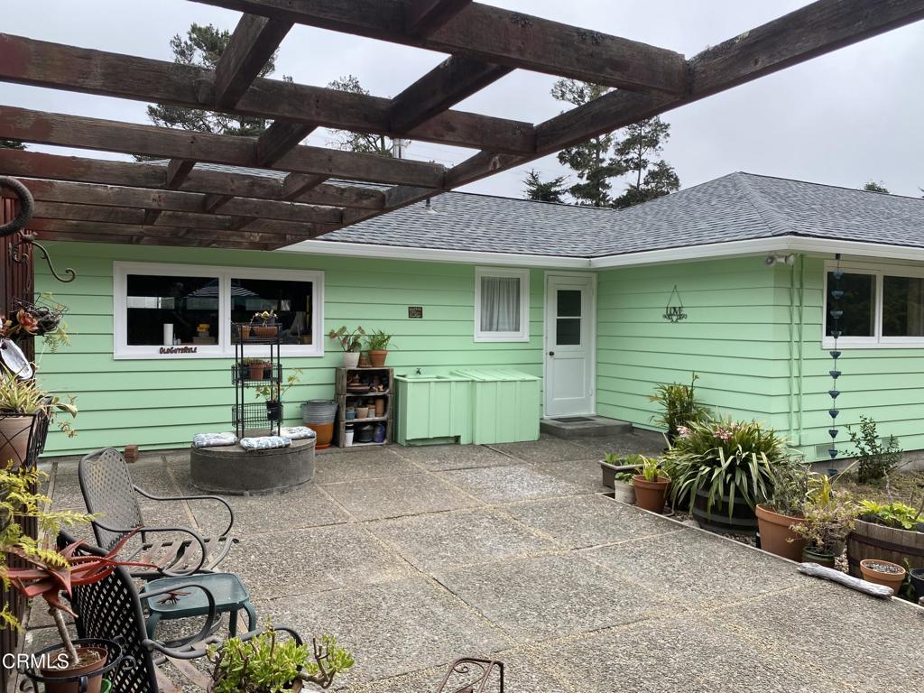 31400 Sherwood Road Fort Bragg, CA 95437 - Photo 42 of 55 a view of a house with a garage and a chair under an umbrella