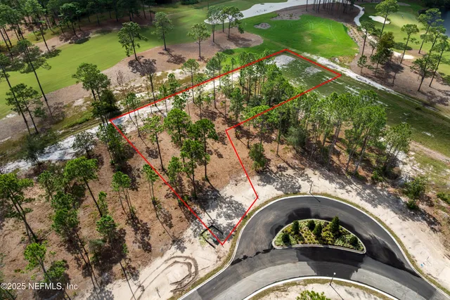 an aerial view of a house a yard swimming pool and outdoor seating