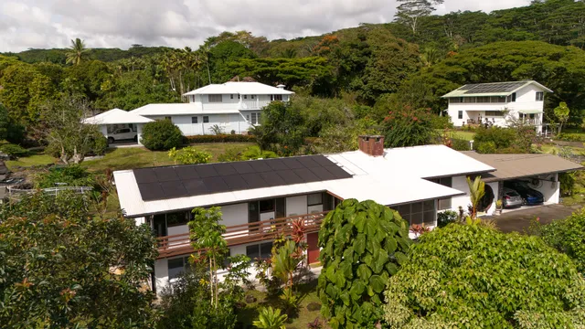 an aerial view of a house with a yard and garden