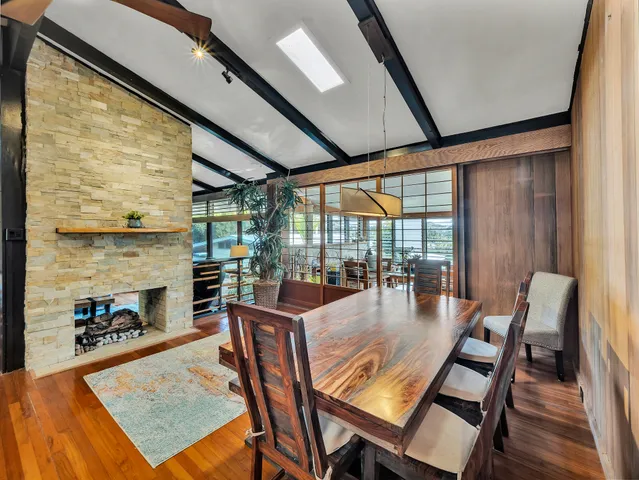 a dining room with furniture wooden floor and a fireplace