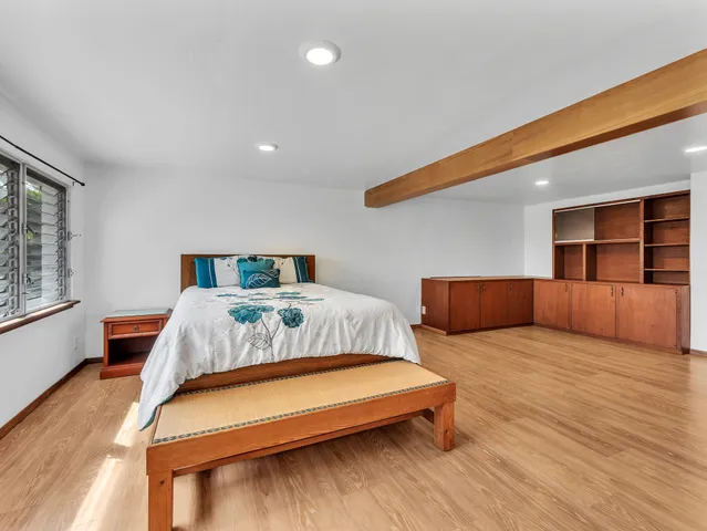 a bedroom with two beds and a large window