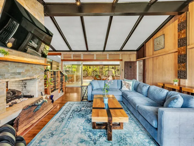 a living room with blue floor to ceiling windows and a table