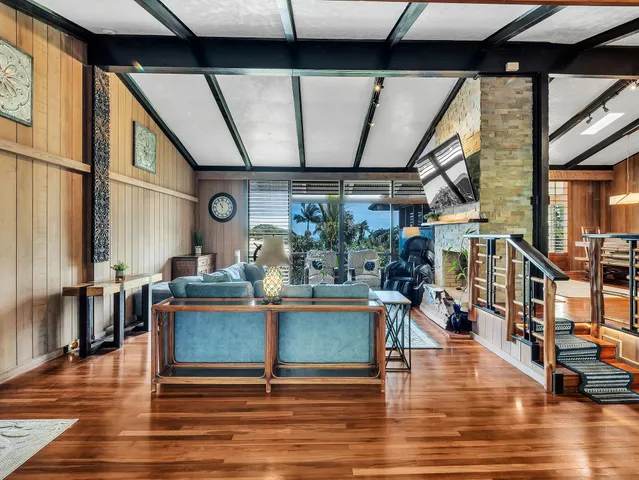 a living room with fireplace furniture and a table