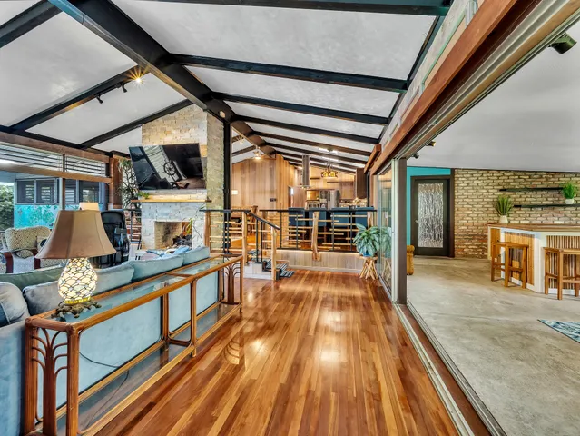 a view of a living room with furniture and wooden floor