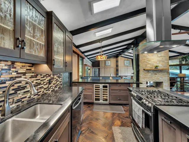 a kitchen with stainless steel appliances granite countertop a stove and a sink