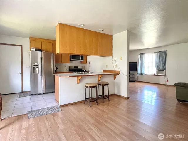 a kitchen with granite countertop a sink and a stove top oven