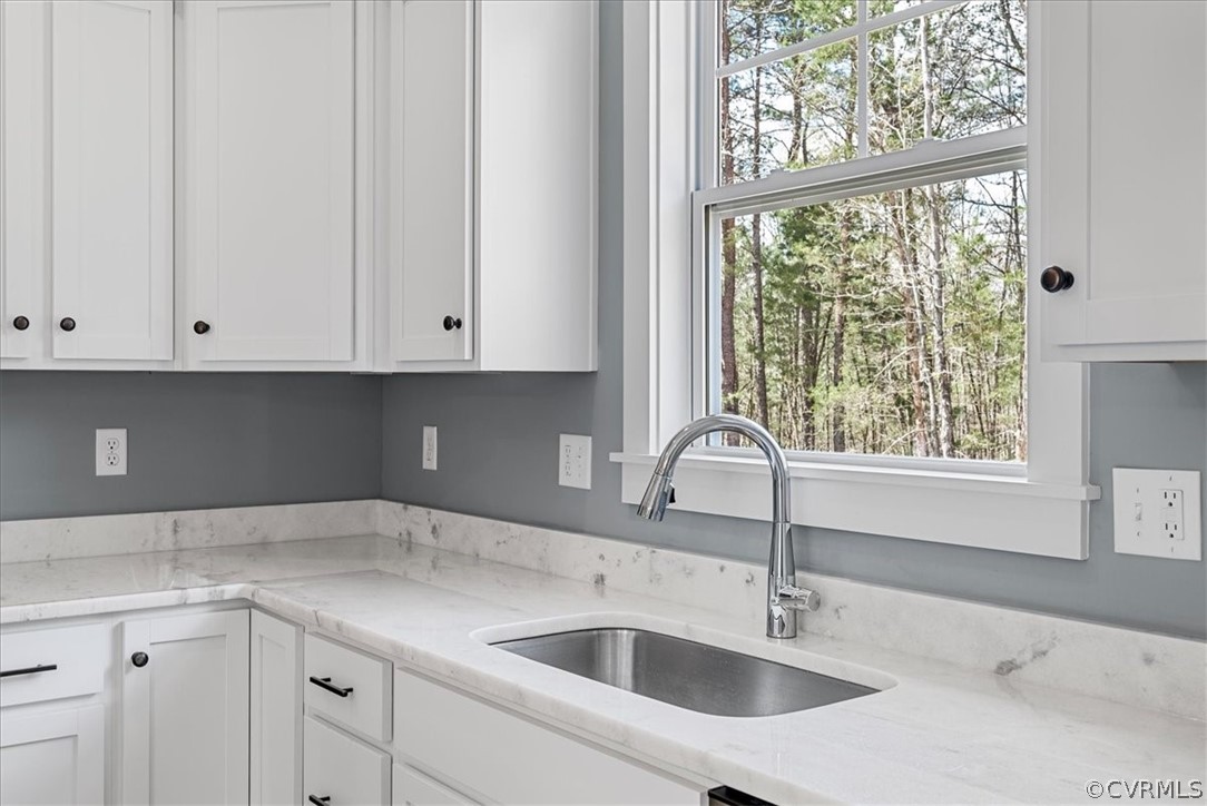 1593 Spreading Oak Road Arvonia, VA 23004 - Photo 20 of 40 a kitchen with a sink and cabinets