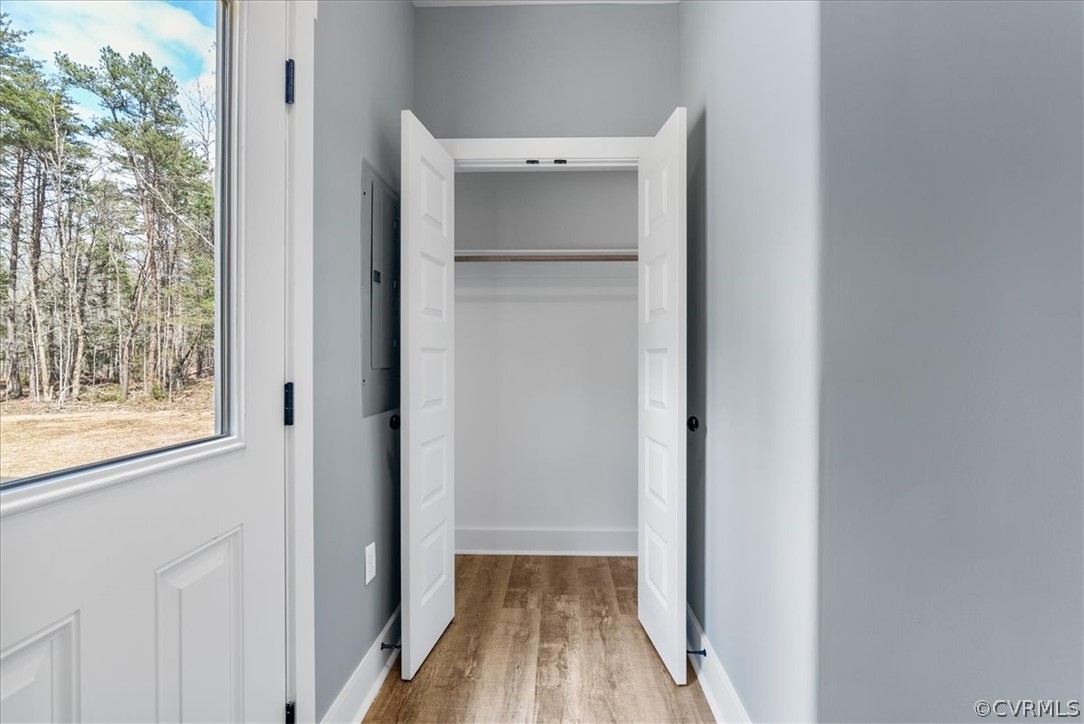 1593 Spreading Oak Road Arvonia, VA 23004 - Photo 21 of 40 a view of a hallway with wooden floor and closet