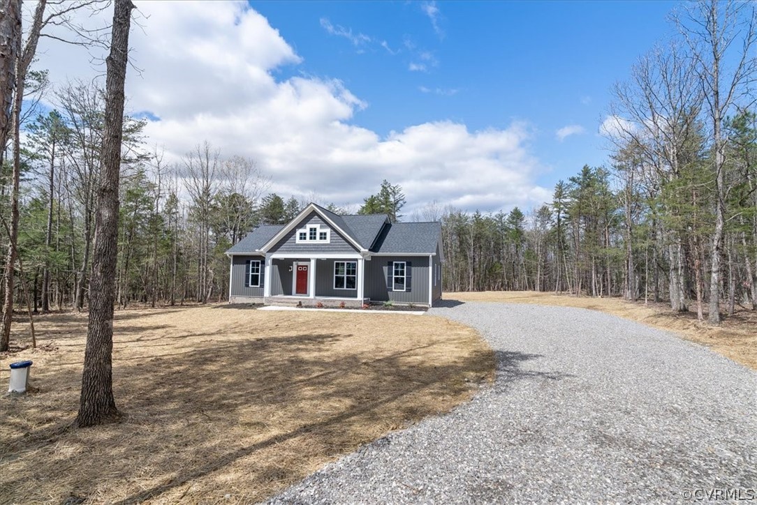 1593 Spreading Oak Road Arvonia, VA 23004 - Photo 3 of 40 a front view of a house with a yard covered in snow