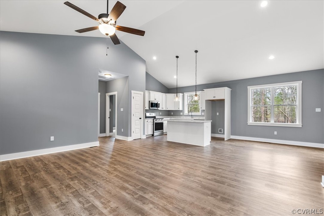 1593 Spreading Oak Road Arvonia, VA 23004 - Photo 33 of 40 an open kitchen with kitchen island and stainless steel appliances