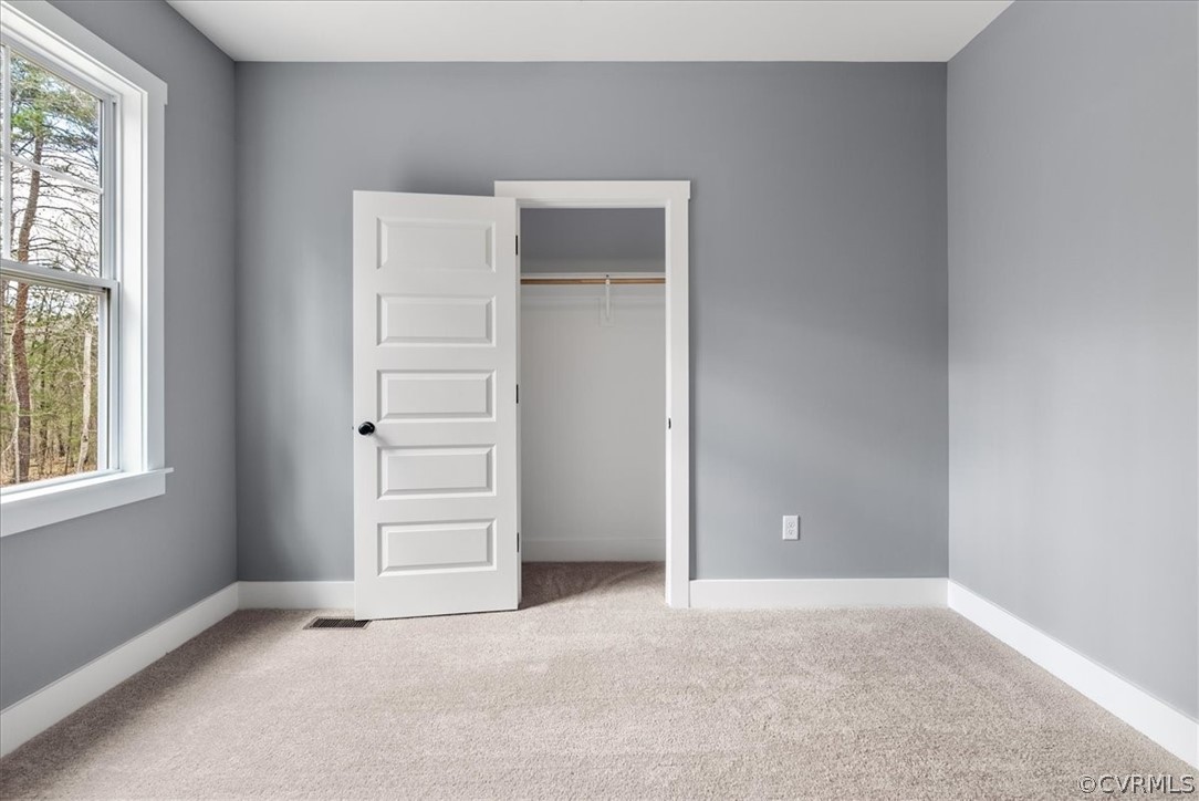 1593 Spreading Oak Road Arvonia, VA 23004 - Photo 34 of 40 an empty room with windows and closet