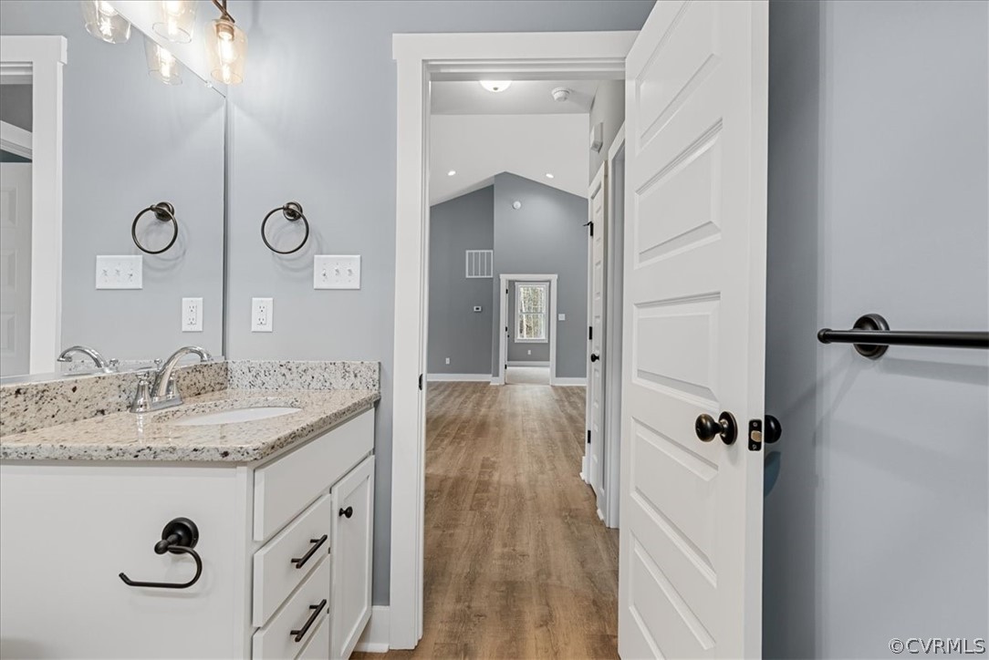 1593 Spreading Oak Road Arvonia, VA 23004 - Photo 38 of 40 a bathroom with a granite countertop sink a mirror and shower