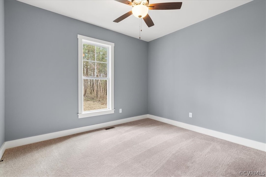 1593 Spreading Oak Road Arvonia, VA 23004 - Photo 39 of 40 an empty room with a window and a ceiling fan