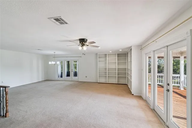 a view of a livingroom with furniture and chandelier fan