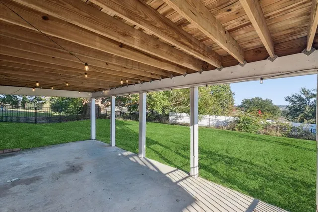 a view of a house with backyard and a tree
