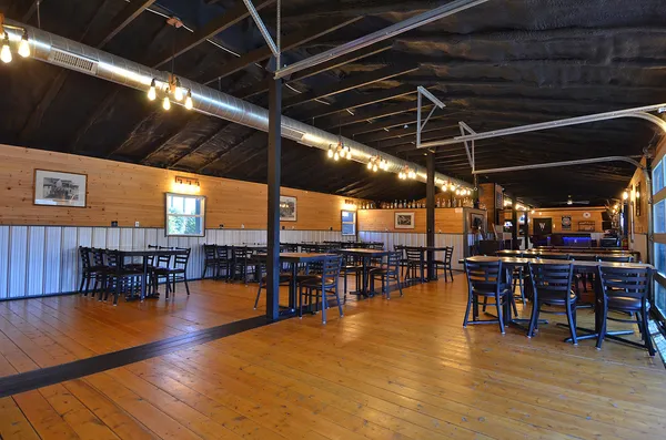 a view of a big room with dining room wooden floor and pool table