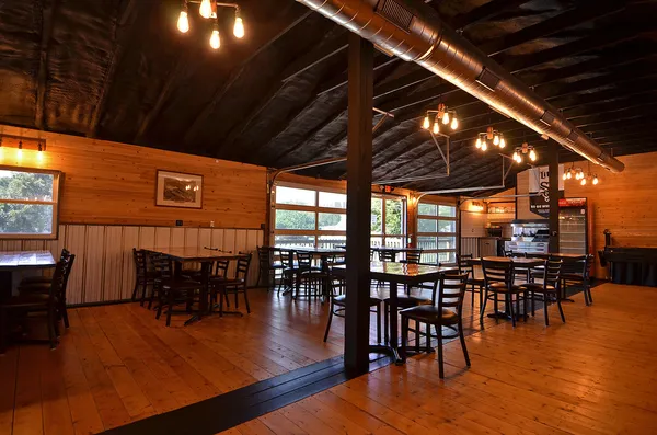 a dining room with furniture wooden floor clock and a rug