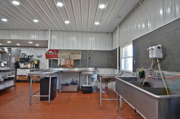a kitchen with lots of counter top space and furniture