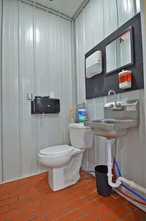 a bathroom with a sink toilet and mirror