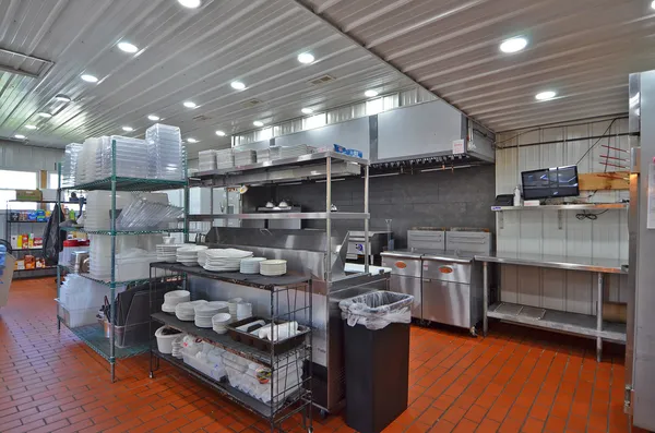 a living room with lots of furniture and kitchen view