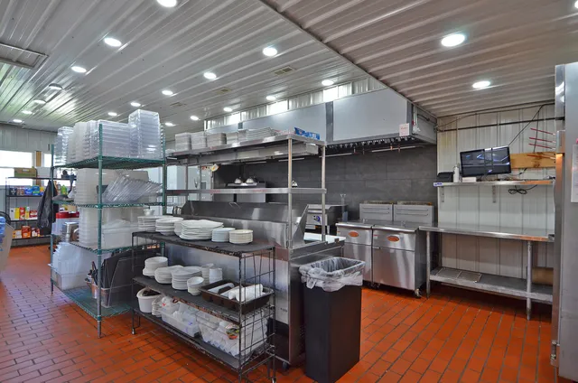 a living room with lots of furniture and kitchen view