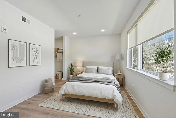 a bedroom with a large bed and a large window