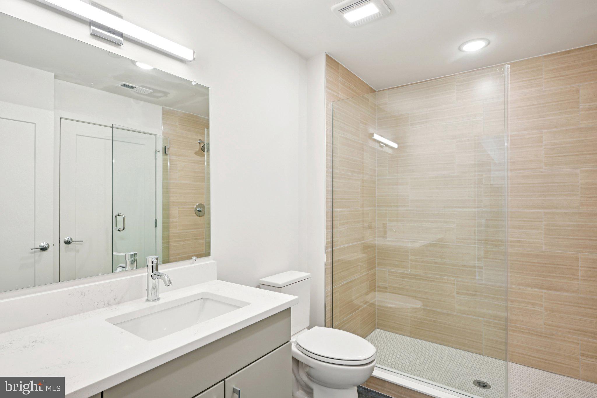 23 Rock Hill Road, Unit 506 Bala Cynwyd, PA 19004 - Photo 5 of 8 a bathroom with a sink a toilet and shower